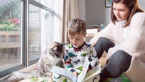 Menino com gato lendo livro